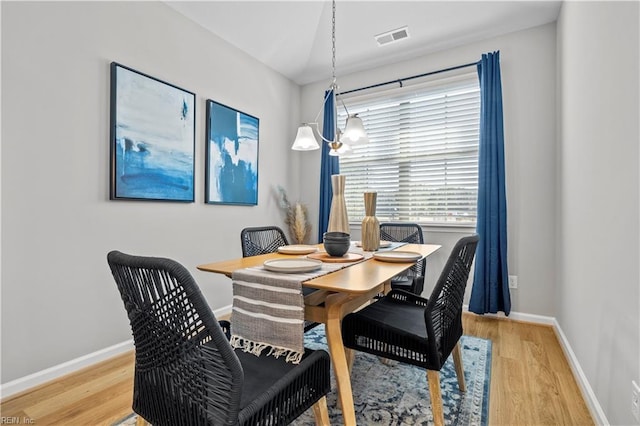 1501 Kathy Ann Way E, Carrollton, VA 23314 - dining room with wood finished floors, baseboards, and a chandelier