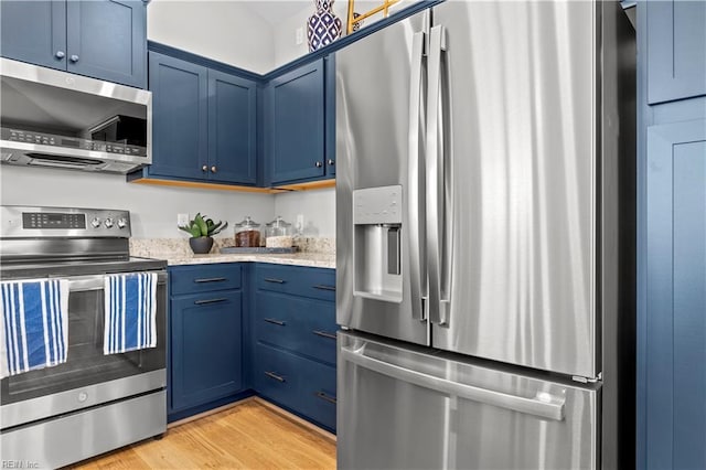 1501 Kathy Ann Way E, Carrollton, VA 23314 - kitchen featuring appliances with stainless steel finishes, blue cabinets, light wood finished floors, and light stone counters