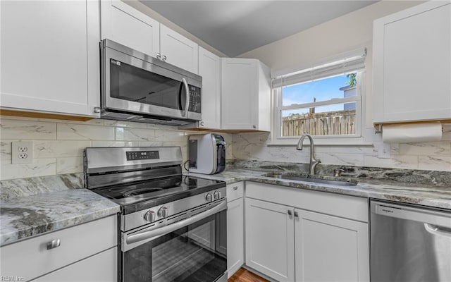 3213 Ashaway Rd, Virginia Beach, VA 23452 - kitchen with appliances with stainless steel finishes, a sink, white cabinets, and light stone counters