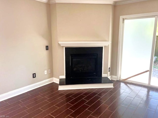 111 Chardonnay Rd, Williamsburg, VA 23185 - unfurnished living room featuring ornamental molding, baseboards, healthy amount of natural light, a fireplace with raised hearth, and dark wood-style flooring