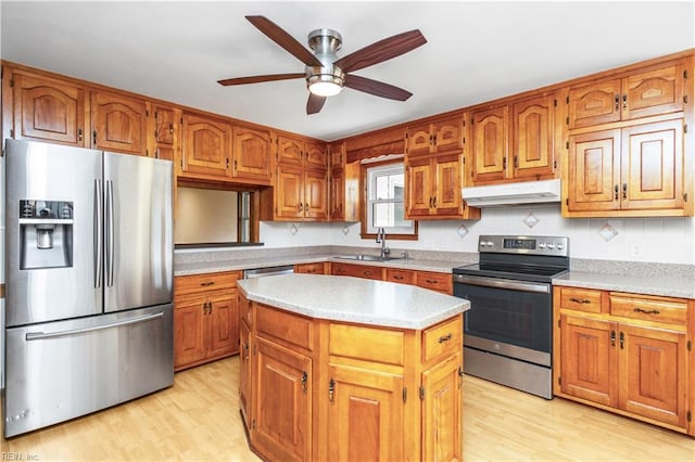 1364 Sir Richard Rd, Virginia Beach, VA 23455 - kitchen featuring stainless steel appliances, under cabinet range hood, a ceiling fan, light wood-style floors, and brown cabinetry