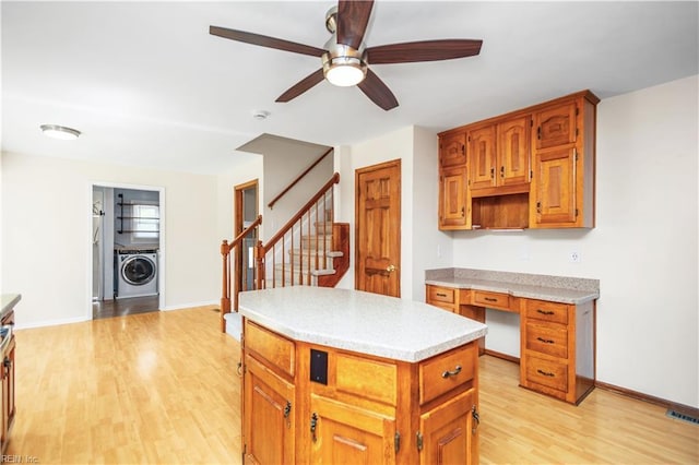 1364 Sir Richard Rd, Virginia Beach, VA 23455 - kitchen with washer / dryer, light wood-type flooring, a kitchen island, light countertops, and ceiling fan