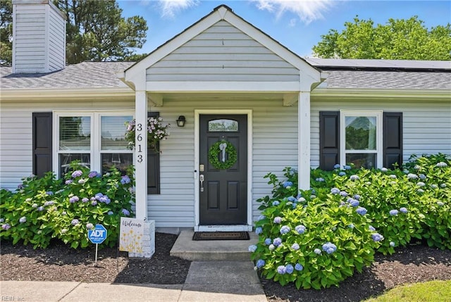 3613 Mostiler Pl, Chesapeake, VA 23323 - doorway to property featuring a chimney, solar panels, and roof with shingles
