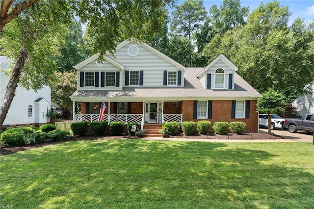 208 Coinjock Run, Yorktown, VA 23693 - view of front of property with covered porch, a front yard, and brick siding