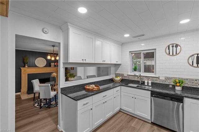1801 Delaney St, Virginia Beach, VA 23464 - kitchen with dishwasher, light wood-style flooring, white cabinetry, dark stone countertops, and backsplash