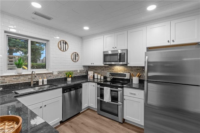 1801 Delaney St, Virginia Beach, VA 23464 - kitchen with stainless steel appliances, white cabinetry, backsplash, and recessed lighting