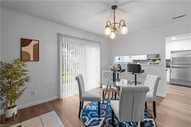 1801 Delaney St, Virginia Beach, VA 23464 - dining area with a chandelier, light wood-type flooring, and a textured ceiling