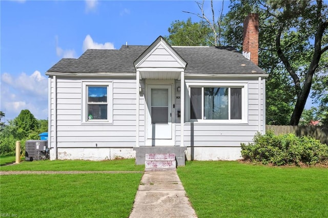 1424 Stewart St, Chesapeake, VA 23324 - bungalow with a chimney, roof with shingles, and cooling unit