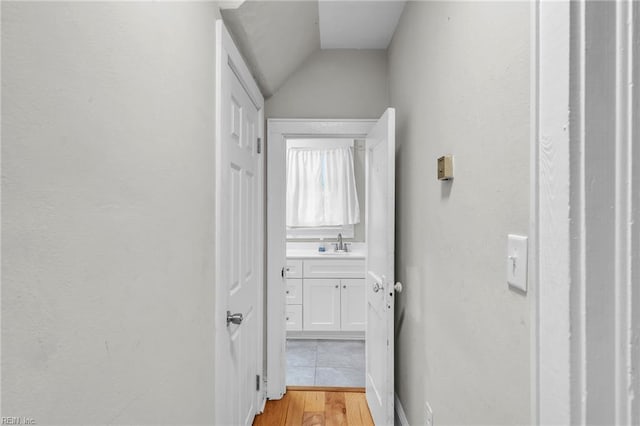 1424 Stewart St, Chesapeake, VA 23324 - corridor with vaulted ceiling, a sink, and light wood finished floors