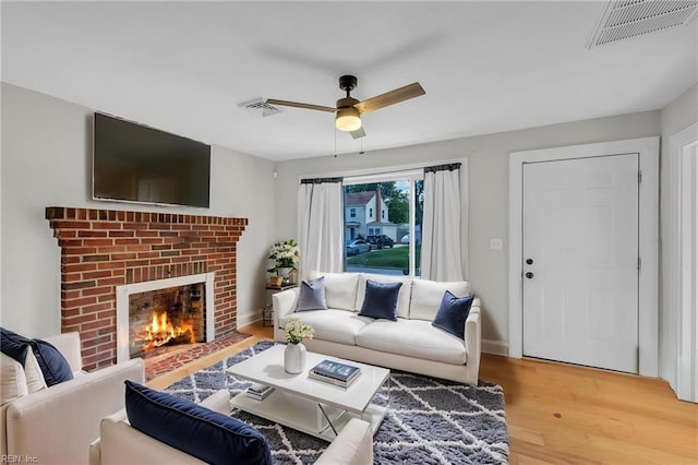 1424 Stewart St, Chesapeake, VA 23324 - living area with light wood finished floors, ceiling fan, a fireplace, and baseboards