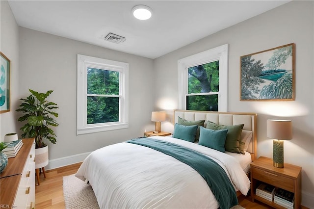 1424 Stewart St, Chesapeake, VA 23324 - bedroom featuring multiple windows, light wood finished floors, and baseboards