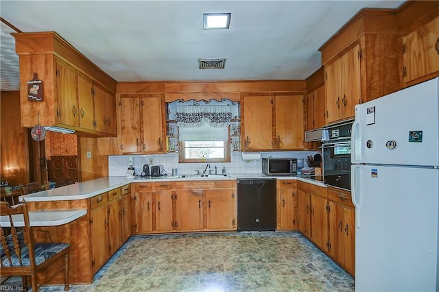 409 Briarfield Dr, Chesapeake, VA 23322 - kitchen with black appliances, a peninsula, a sink, and brown cabinets