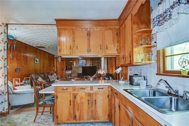 409 Briarfield Dr, Chesapeake, VA 23322 - kitchen with a sink, open floor plan, brown cabinets, a peninsula, and wooden walls