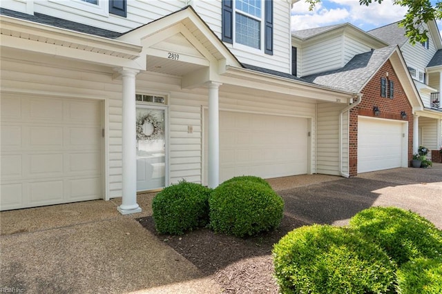 2819 Rose Garden Way, Virginia Beach, VA 23456 - property entrance with a shingled roof, an attached garage, and asphalt driveway