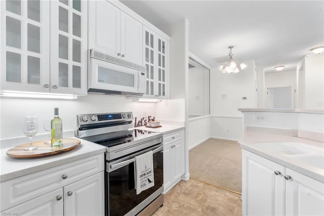 2819 Rose Garden Way, Virginia Beach, VA 23456 - kitchen with white microwave, electric stove, light countertops, and white cabinetry