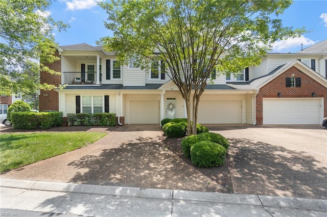 2819 Rose Garden Way, Virginia Beach, VA 23456 - view of property featuring brick siding, driveway, a balcony, and a garage
