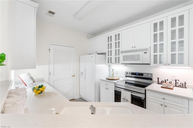 2819 Rose Garden Way, Virginia Beach, VA 23456 - kitchen featuring white appliances, white cabinets, light countertops, and glass insert cabinets