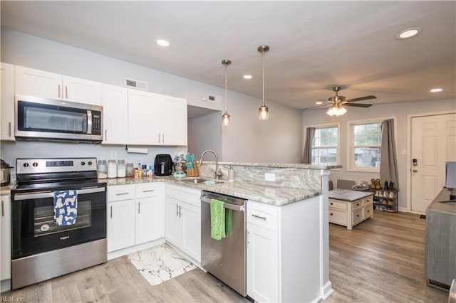 2511 Pringle Dr, Chesapeake, VA 23325 - kitchen featuring stainless steel appliances, a sink, a peninsula, white cabinetry, and recessed lighting