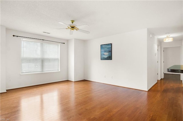 303 Settlement Dr Unit 303, Williamsburg, VA 23188 - spare room with wood finished floors, ceiling fan, baseboards, and a textured ceiling