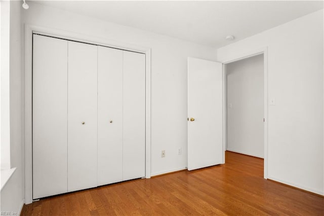 303 Settlement Dr Unit 303, Williamsburg, VA 23188 - unfurnished bedroom with a closet, wood finished floors, and baseboards