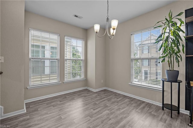 249 Carnelian St Unit 85A, Virginia Beach, VA 23462 - unfurnished room with wood finished floors, a chandelier, and baseboards