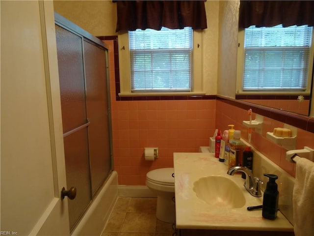 101 Lumar Rd, Smithfield, VA 23430 - full bathroom featuring tile patterned flooring, toilet, vanity, enclosed tub / shower combo, and tile walls