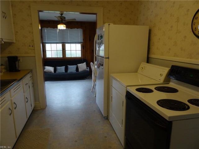 101 Lumar Rd, Smithfield, VA 23430 - kitchen featuring range with electric stovetop, wallpapered walls, white cabinets, a ceiling fan, and wainscoting