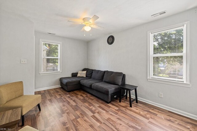 127 Clyde St, Hampton, VA 23669 - living area with healthy amount of natural light, a ceiling fan, wood finished floors, and baseboards