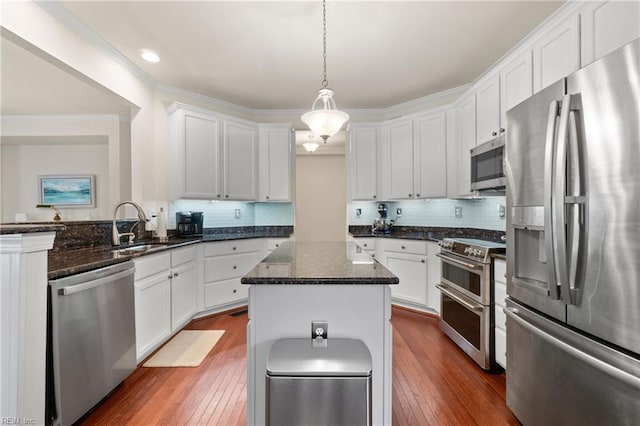 313 Preservation Reach Reach, Chesapeake, VA 23320 - kitchen featuring appliances with stainless steel finishes, dark wood-style floors, crown molding, a sink, and white cabinetry