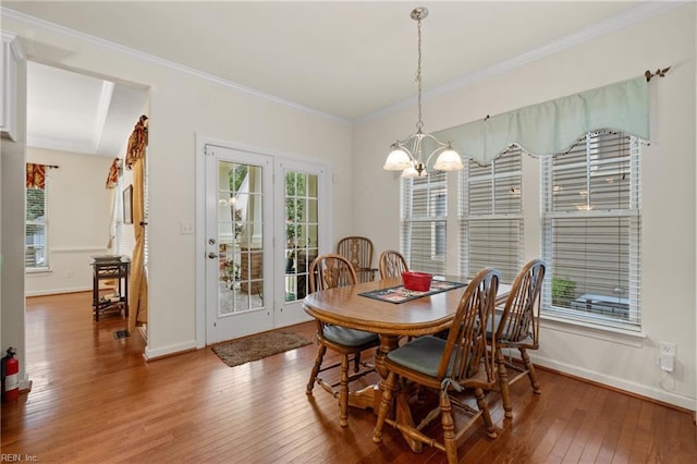 313 Preservation Reach Reach, Chesapeake, VA 23320 - dining area featuring hardwood / wood-style floors, a chandelier, healthy amount of natural light, ornamental molding, and baseboards