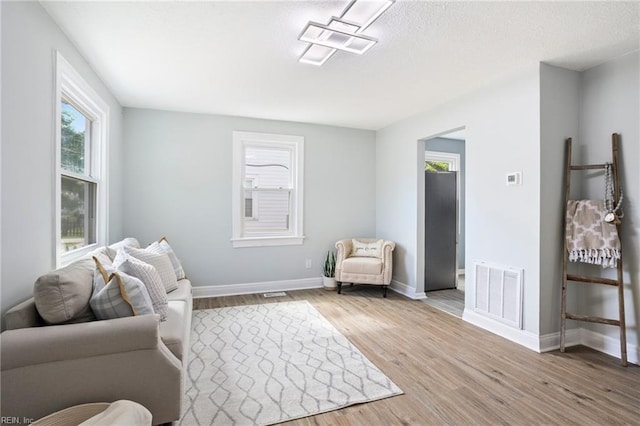 31 W Sunset Rd, Hampton, VA 23669 - living room with light wood-style flooring, healthy amount of natural light, and baseboards