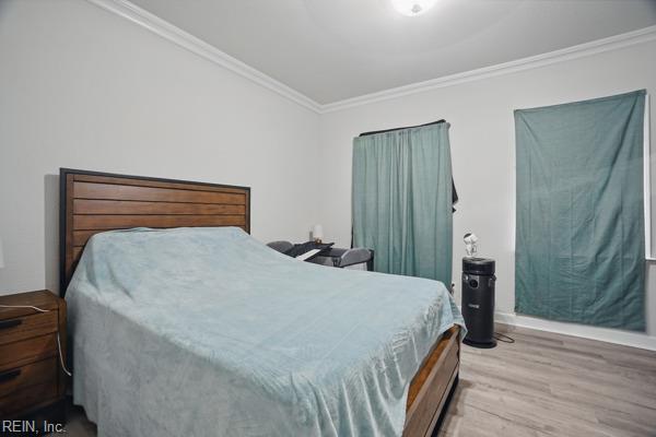 1918 Prentis Ave, Portsmouth, VA 23704 - bedroom featuring crown molding, wood finished floors, and baseboards