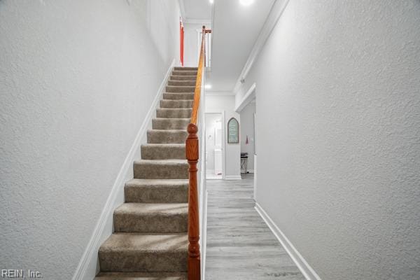 1918 Prentis Ave, Portsmouth, VA 23704 - stairs featuring a textured wall, wood finished floors, ornamental molding, and baseboards
