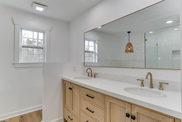 2417 Cedar Rd, Chesapeake, VA 23323 - bathroom featuring a tile shower, wood finished floors, double vanity, and baseboards