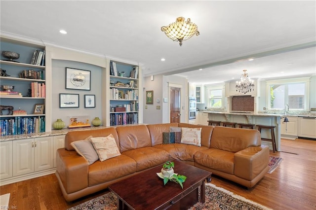 511 Brackenridge Ave, Norfolk, VA 23505 - living room with a chandelier, light wood-style floors, ornamental molding, built in features, and recessed lighting