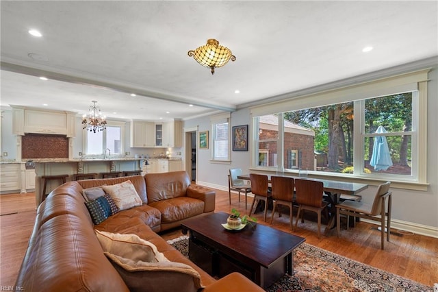 511 Brackenridge Ave, Norfolk, VA 23505 - living area with baseboards, healthy amount of natural light, a chandelier, light wood-style flooring, and crown molding