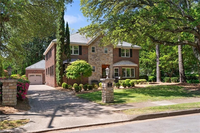 511 Brackenridge Ave, Norfolk, VA 23505 - view of front of property with driveway, a garage, brick siding, stone siding, and a front yard