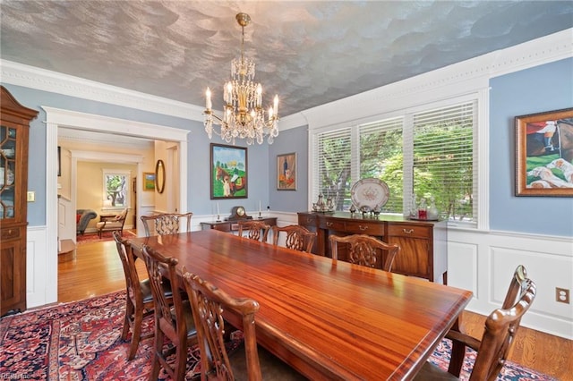 511 Brackenridge Ave, Norfolk, VA 23505 - dining space featuring a chandelier, wood finished floors, healthy amount of natural light, wainscoting, and ornamental molding