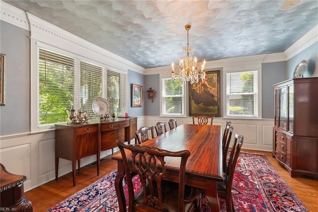 511 Brackenridge Ave, Norfolk, VA 23505 - dining area featuring a chandelier, a decorative wall, light wood finished floors, a wainscoted wall, and ornamental molding