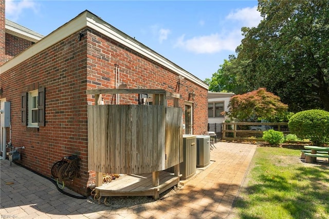 511 Brackenridge Ave, Norfolk, VA 23505 - view of property exterior featuring brick siding, central air condition unit, and a patio