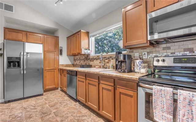4917 Erskine St, Virginia Beach, VA 23462 - kitchen featuring stainless steel appliances, a sink, lofted ceiling, light countertops, and backsplash