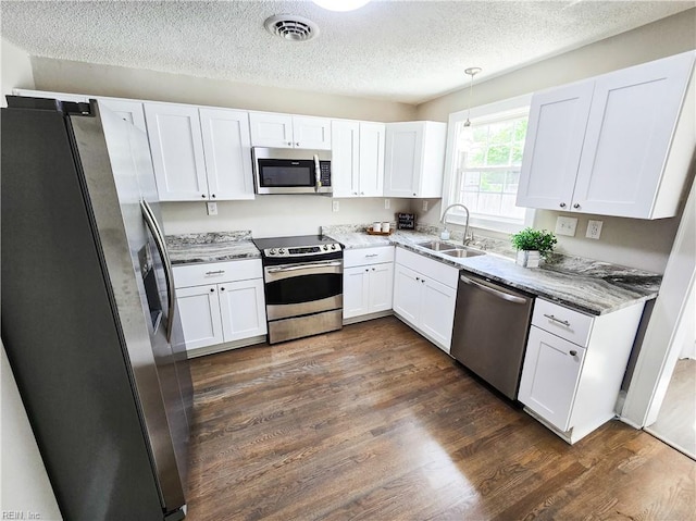 1251 Little Bay Ave, Norfolk, VA 23503 - kitchen with stainless steel appliances, a sink, white cabinets, and a textured ceiling
