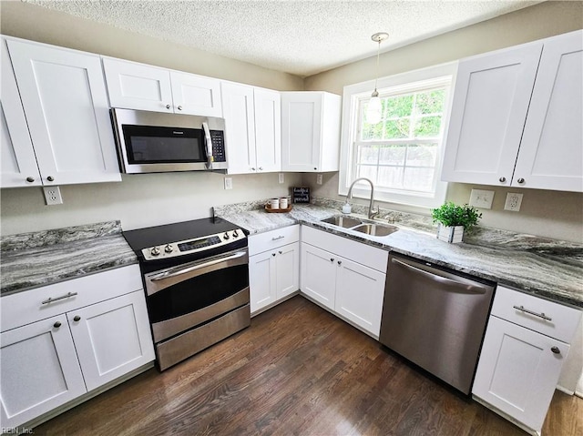 1251 Little Bay Ave, Norfolk, VA 23503 - kitchen featuring stainless steel appliances, a sink, dark wood-type flooring, white cabinets, and a textured ceiling