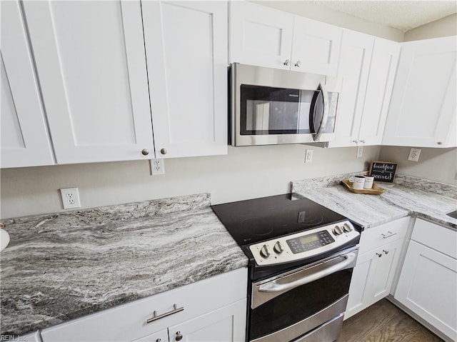 1251 Little Bay Ave, Norfolk, VA 23503 - kitchen with stainless steel appliances, white cabinetry, and light stone counters