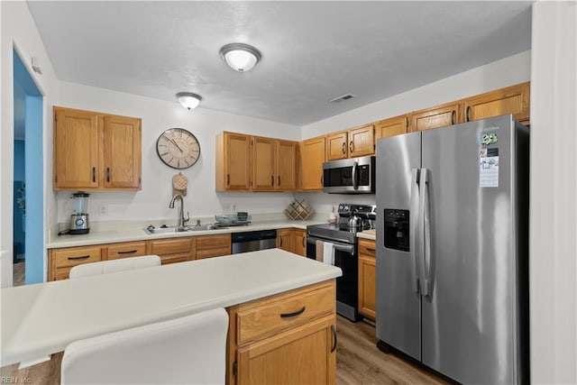 3012 Trappers Run, Chesapeake, VA 23321 - kitchen featuring appliances with stainless steel finishes, a sink, light countertops, and light wood-type flooring