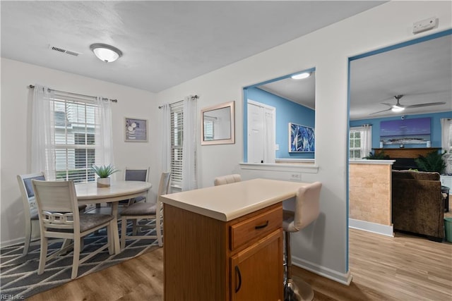 3012 Trappers Run, Chesapeake, VA 23321 - kitchen with wood finished floors, brown cabinets, ceiling fan, and baseboards