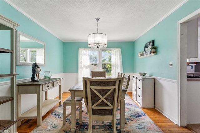 5801 Lancelot Dr, Virginia Beach, VA 23464 - dining room with ornamental molding, a chandelier, light wood finished floors, and a textured ceiling
