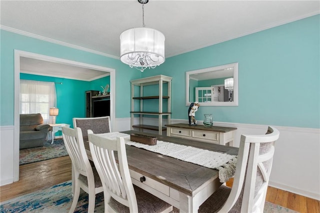 5801 Lancelot Dr, Virginia Beach, VA 23464 - dining room featuring a chandelier, ornamental molding, wood finished floors, and wainscoting