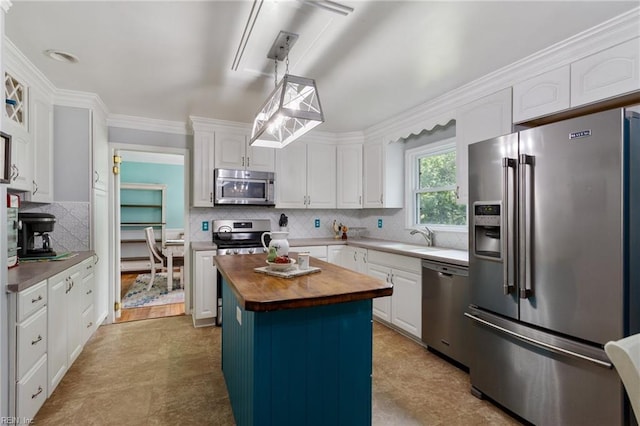 5801 Lancelot Dr, Virginia Beach, VA 23464 - kitchen featuring stainless steel appliances, butcher block counters, white cabinetry, tasteful backsplash, and a sink