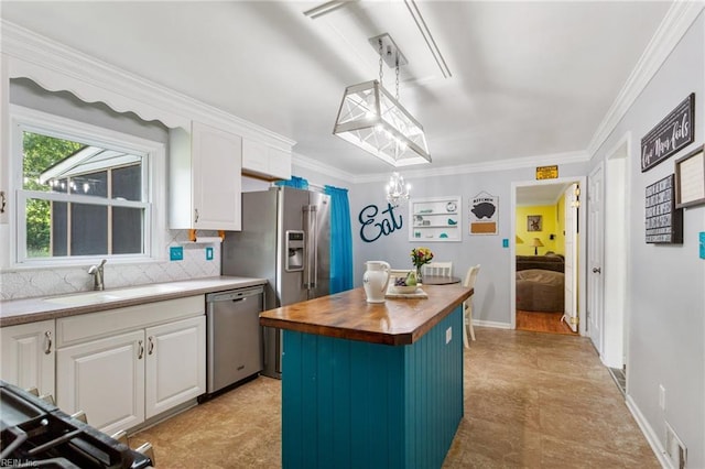5801 Lancelot Dr, Virginia Beach, VA 23464 - kitchen featuring appliances with stainless steel finishes, butcher block counters, white cabinets, a sink, and a center island